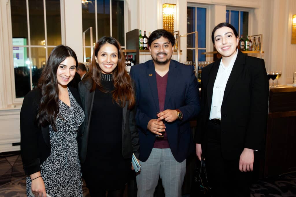 Photo of four attendees posing together from the 2025 Evening for Equality event.